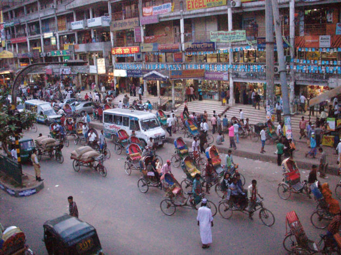 This is a tipical street scene in Dhaka, Bangladesh. The traffic is absolutely crazy, and every one is risking life and limb, by just getting in a rickshaw