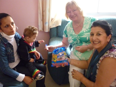 Thelma giving sweets and toys that were sent from England