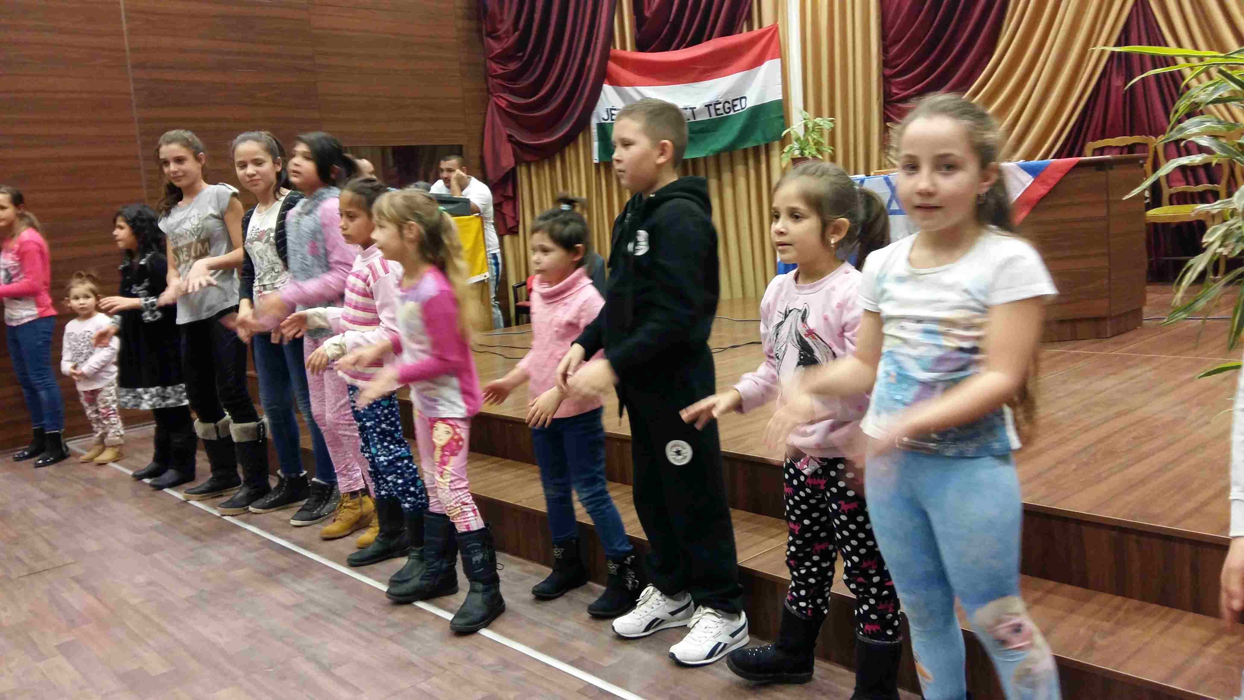 The children dancing in the Sajsantpeter Church in
        Hungary